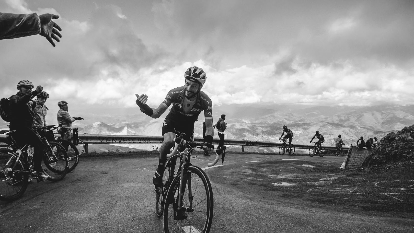 Cyclist on a mountain road with a scenic background